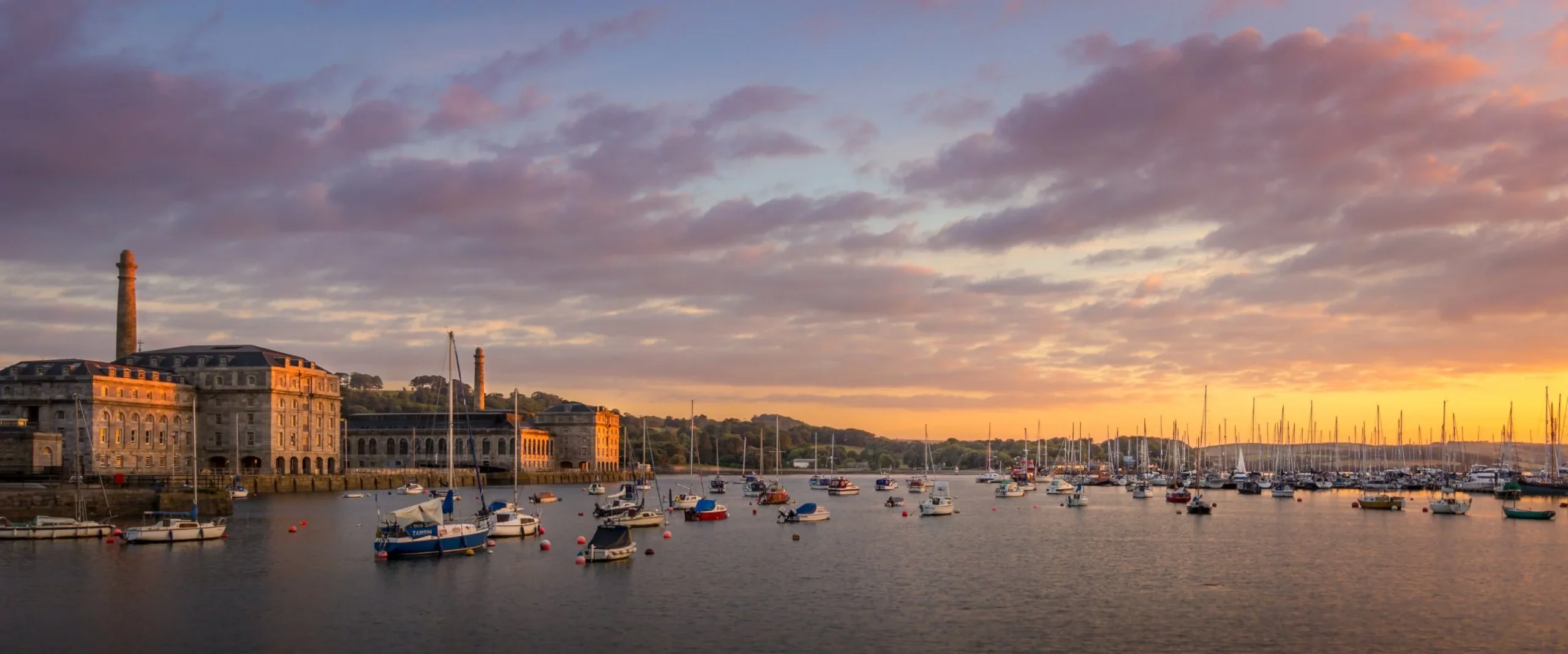 Royal William Yard and moored boats at sunset, Plymouth